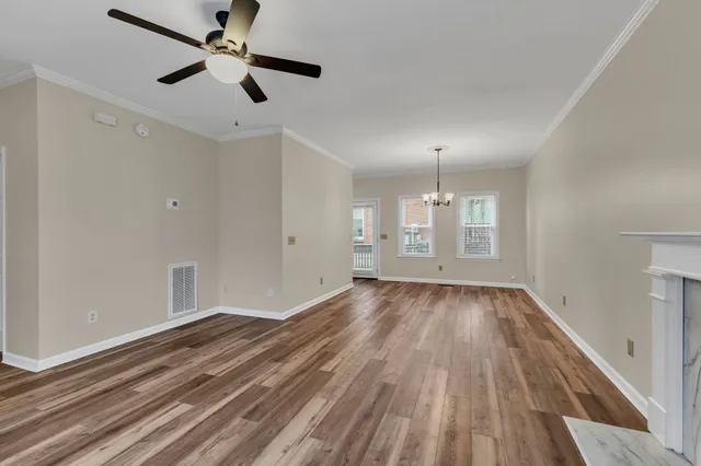 wooden floor in an empty room with a window