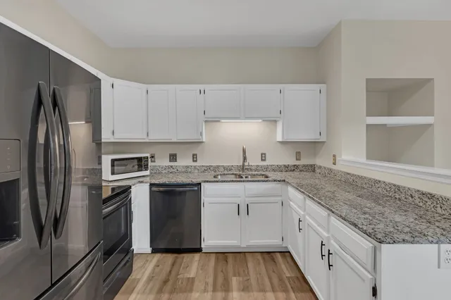a kitchen with a sink stove and refrigerator