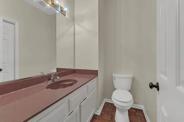 a bathroom with a toilet sink and mirror