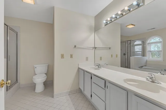 a bathroom with a toilet sink and mirror