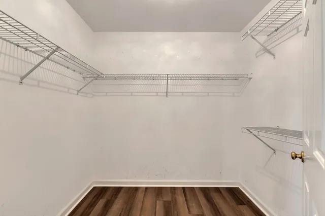 a view of walk in closet with empty racks