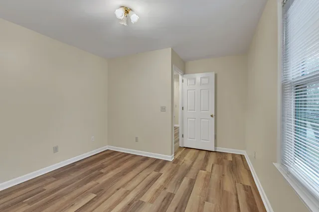 a view of a room with wooden floor and a window