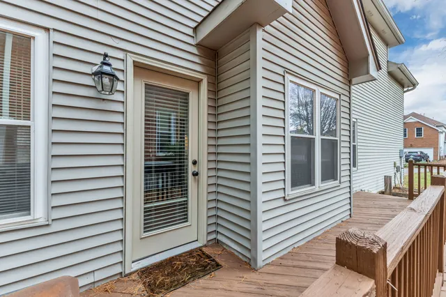 a view of a house with a small yard and wooden fence
