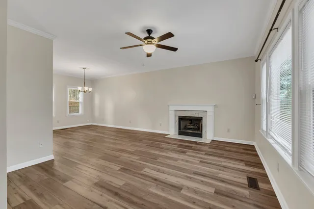 a view of an empty room with window and fire place