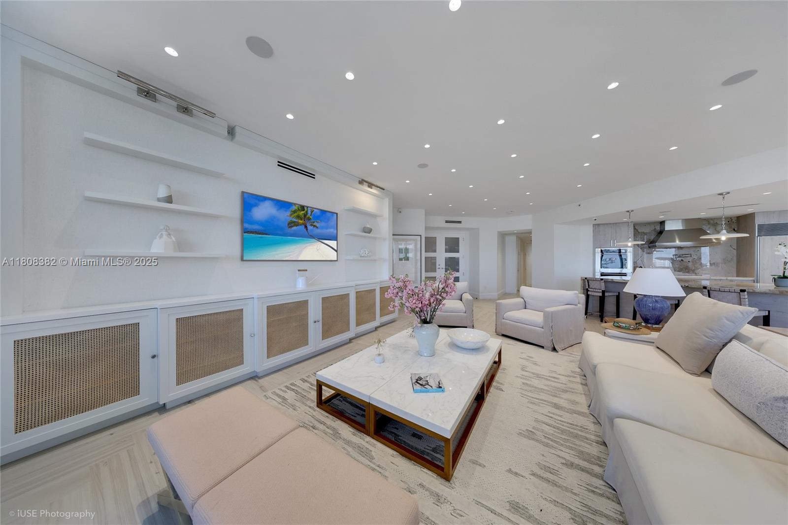 10225 Collins Avenue, Unit 604 Bal Harbour, FL 33154 - Photo 1 of 37 a living room with furniture and a flat screen tv