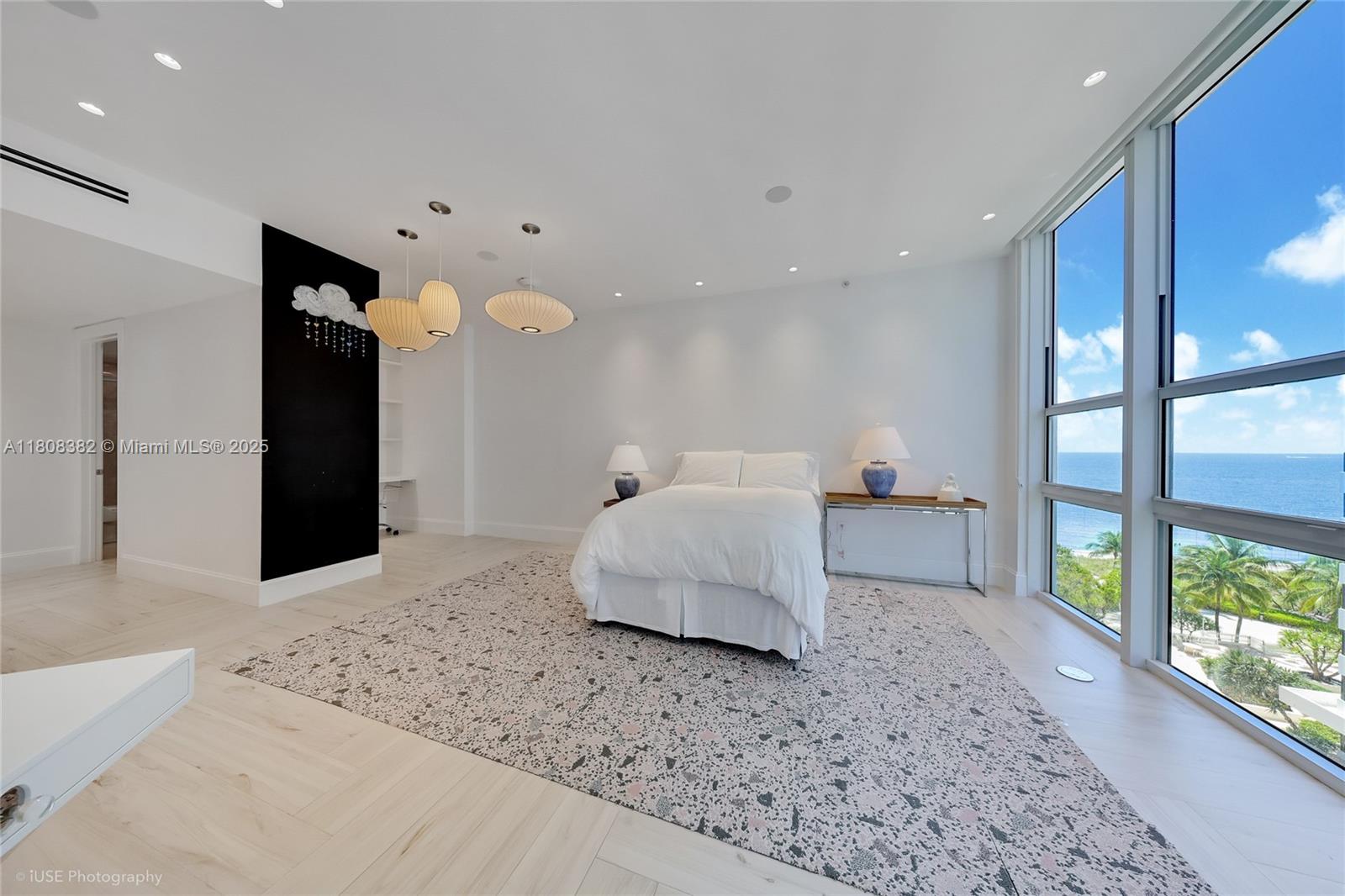 10225 Collins Avenue, Unit 604 Bal Harbour, FL 33154 - Photo 12 of 37 a spacious bedroom with a large bed and a large window