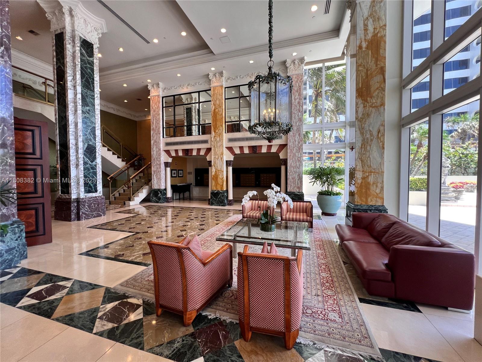 10225 Collins Avenue, Unit 604 Bal Harbour, FL 33154 - Photo 28 of 37 a living room with furniture fireplace and flat screen tv