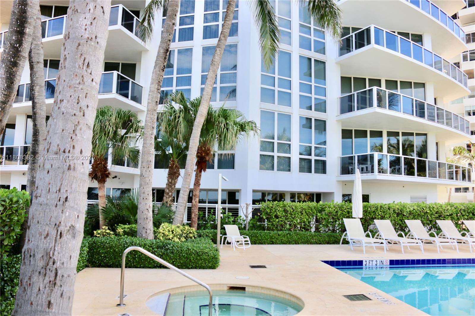 10225 Collins Avenue, Unit 604 Bal Harbour, FL 33154 - Photo 30 of 37 a front view of a multi story building with yard