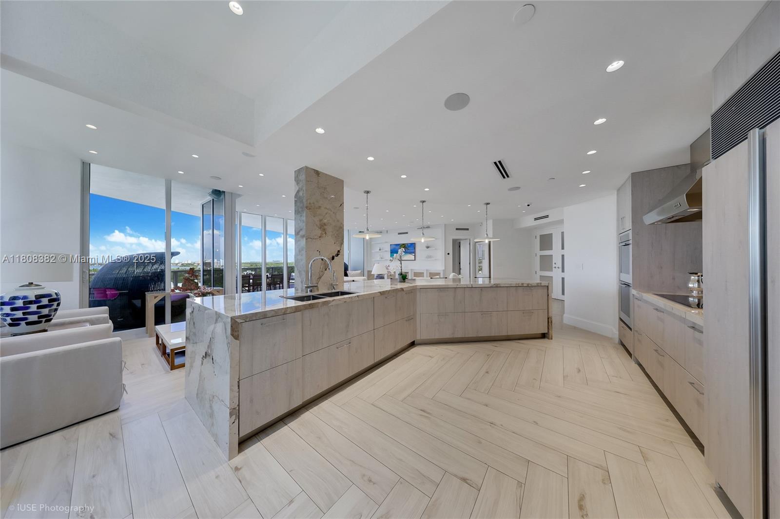 10225 Collins Avenue, Unit 604 Bal Harbour, FL 33154 - Photo 4 of 37 a large white kitchen with a large counter top appliances and cabinets