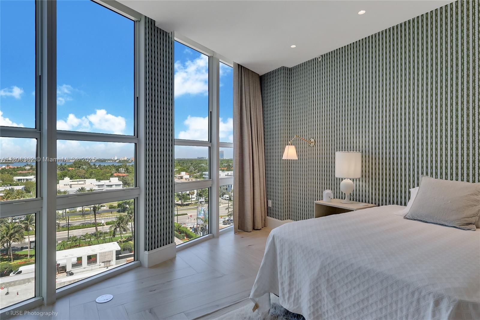 10225 Collins Avenue, Unit 604 Bal Harbour, FL 33154 - Photo 8 of 37 a bedroom with a large window and a balcony