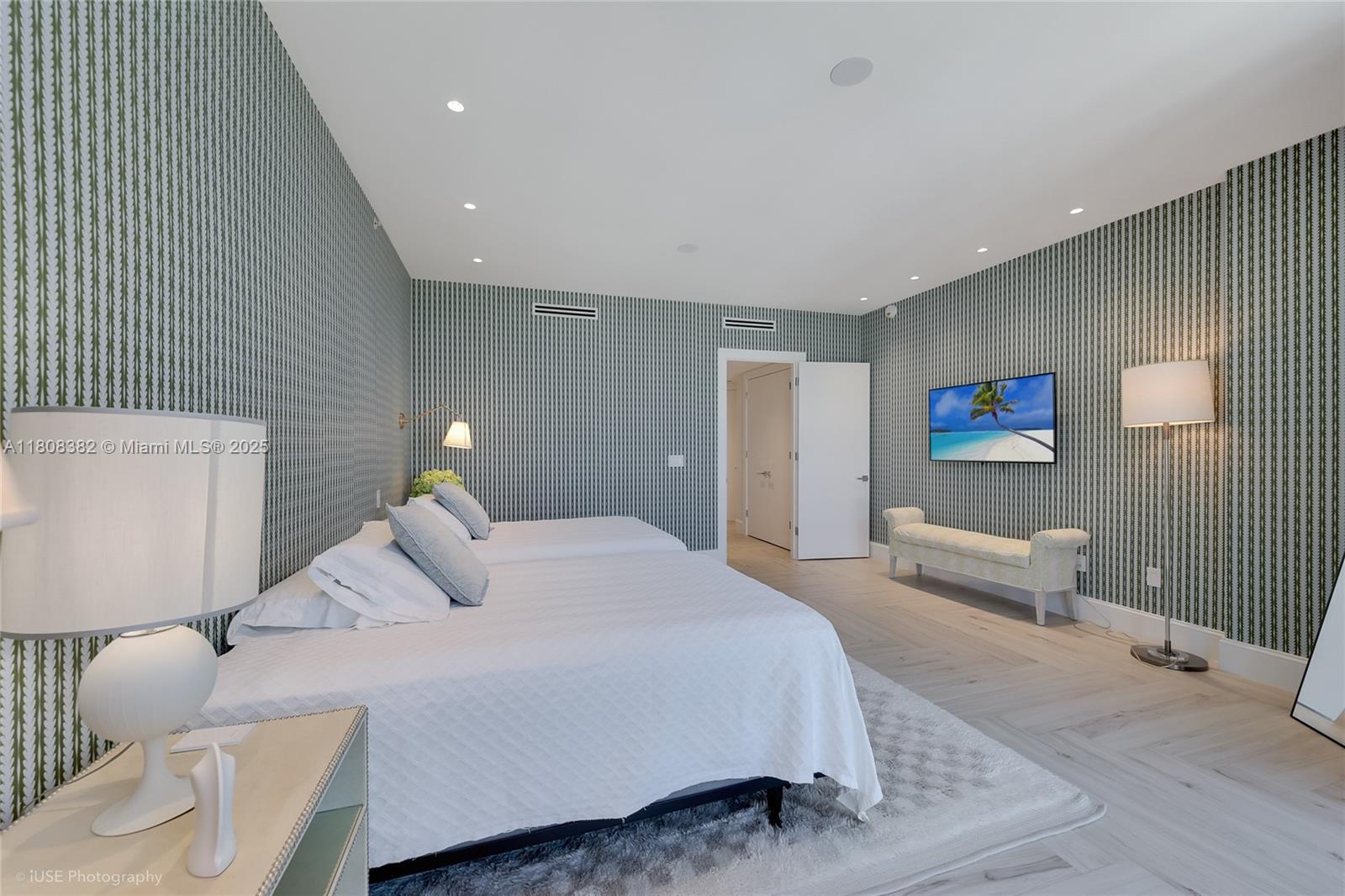 10225 Collins Avenue, Unit 604 Bal Harbour, FL 33154 - Photo 9 of 37 a bedroom with a bed and furniture