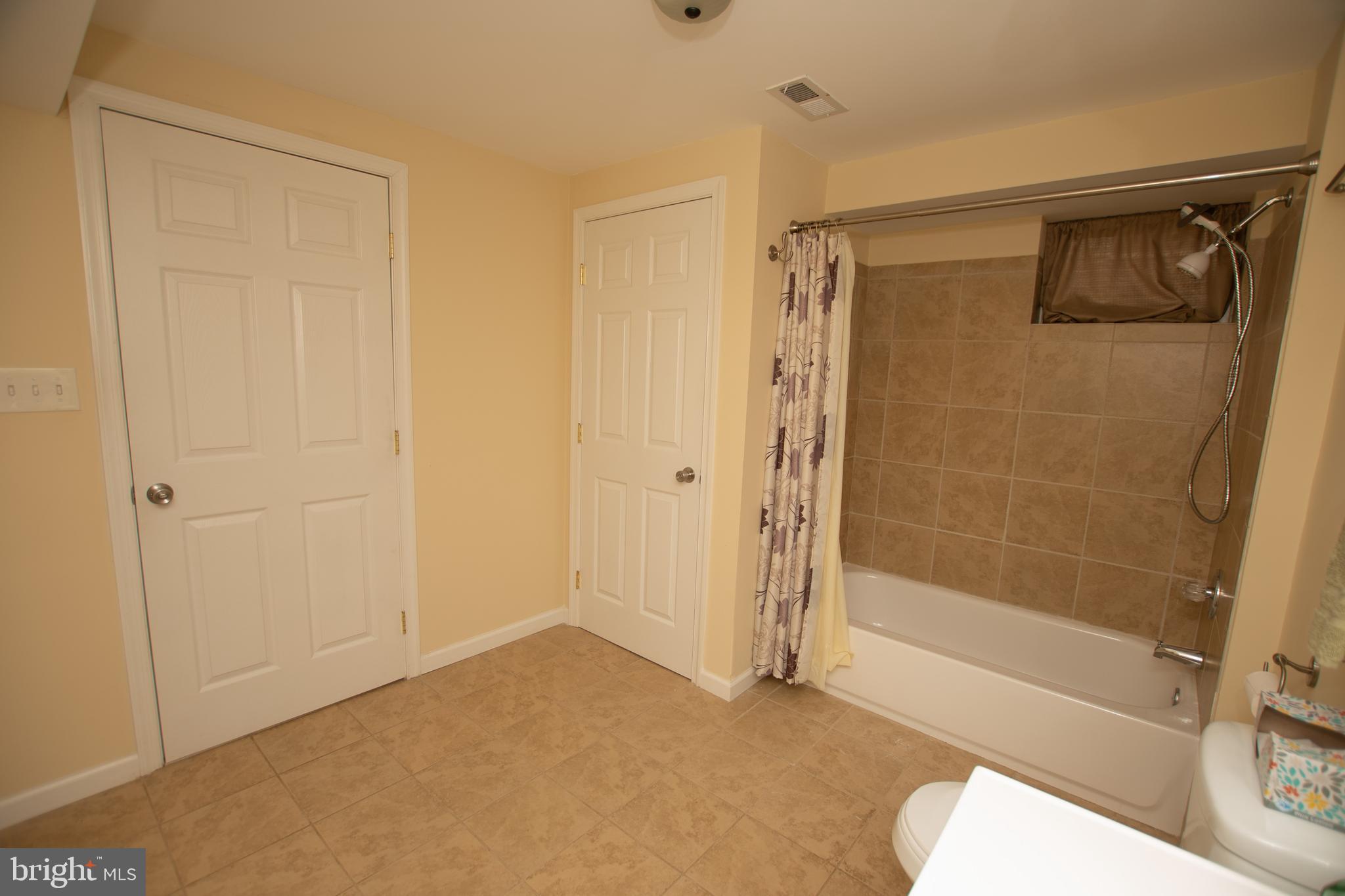 67 Edmondson Ridge Road Baltimore, MD 21228 - Photo 34 of 41 a bathroom with a shower and a tub