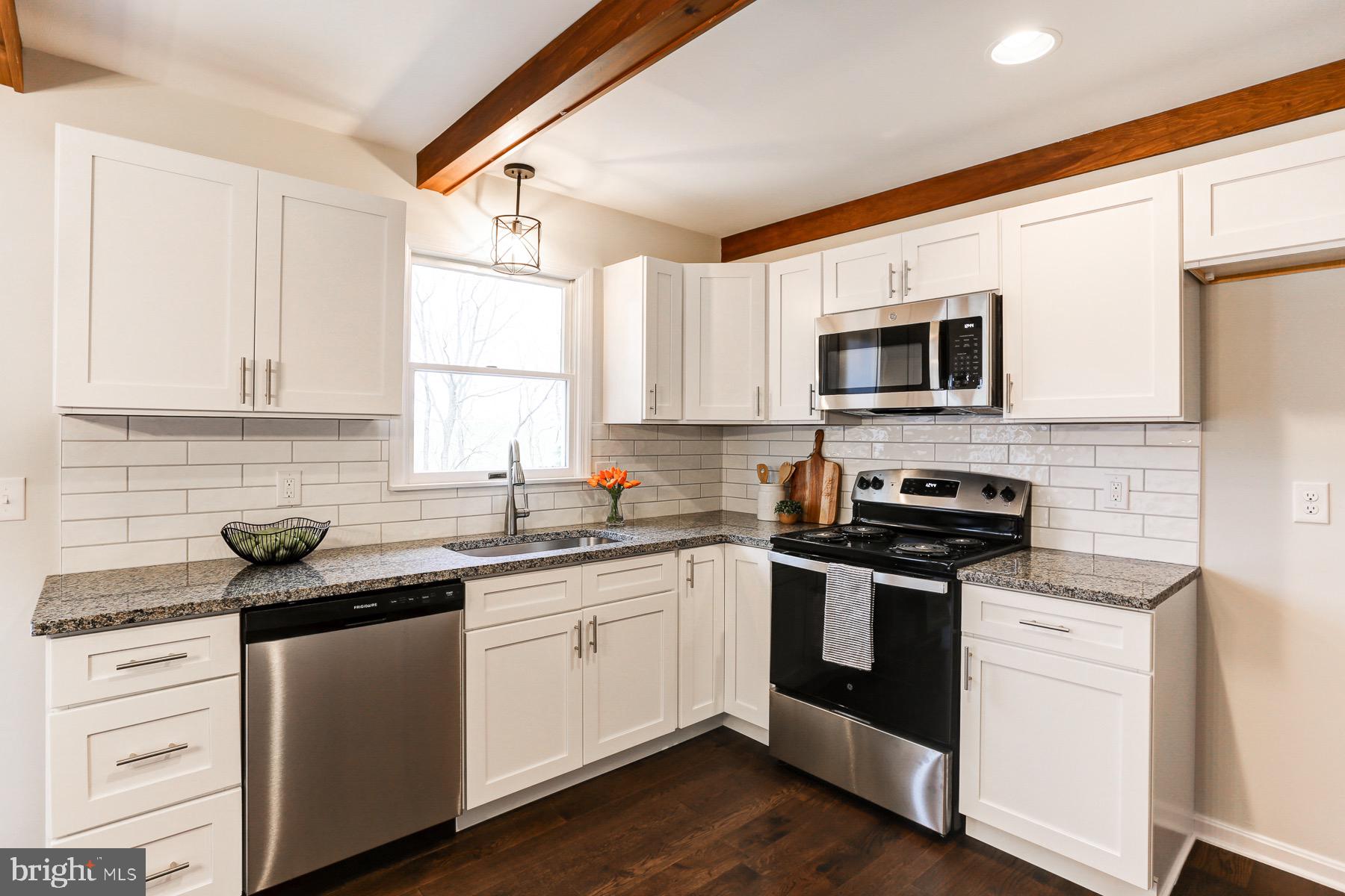 58 Foreman Road Elizabethtown, PA 17022 - Photo 13 of 31 a kitchen with stainless steel appliances a sink dishwasher stove and microwave with wooden floor