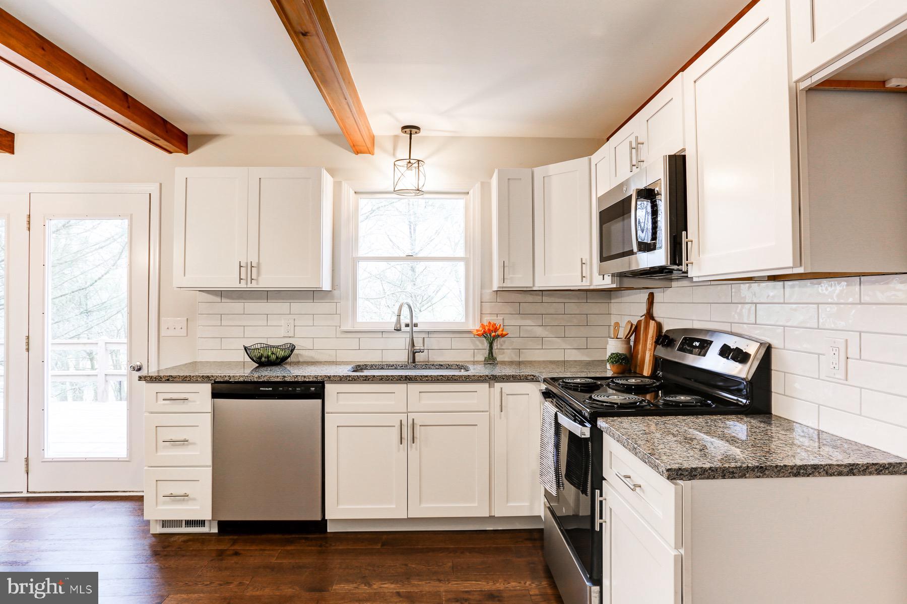 58 Foreman Road Elizabethtown, PA 17022 - Photo 17 of 31 a kitchen with granite countertop white cabinets and white appliances