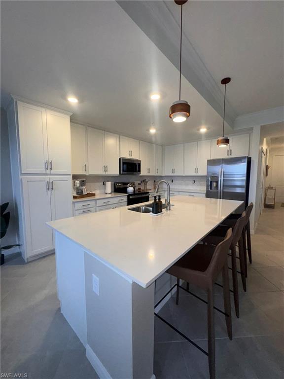 5583 Double Eagle Circle, Unit 4112 Ave Maria, FL 34142 - Photo 2 of 36 a kitchen with kitchen island a stove a table and chairs