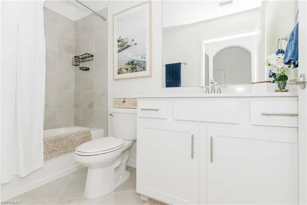a view of a room with lots of wooden furniture and a kitchen