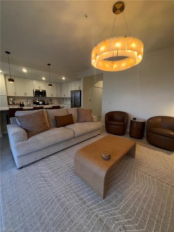 5583 Double Eagle Circle, Unit 4112 Ave Maria, FL 34142 - Photo 3 of 36 a living room with furniture and a chandelier