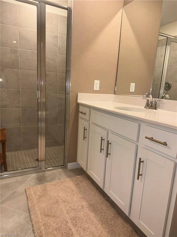 5583 Double Eagle Circle, Unit 4112 Ave Maria, FL 34142 - Photo 5 of 36 a bathroom with a double vanity sink mirror and shower