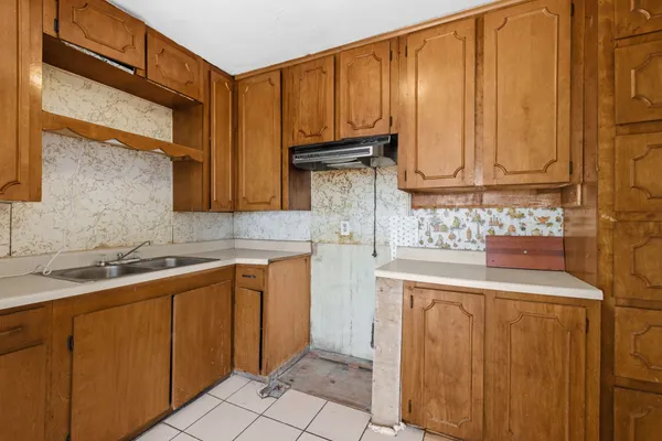 a kitchen with stainless steel appliances granite countertop a sink a stove and cabinets