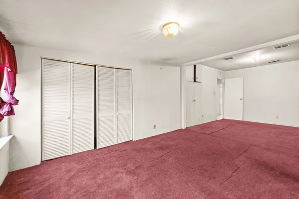 a view of a room with a large bed