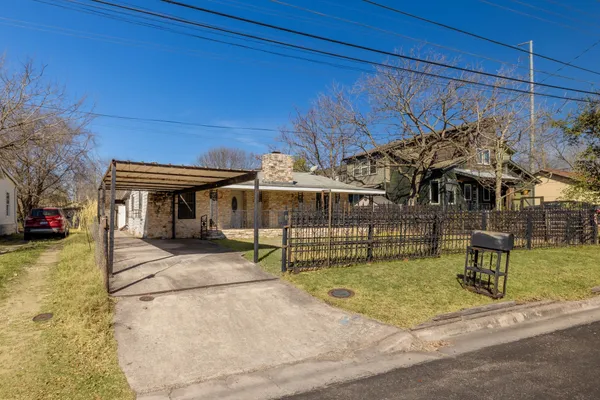 a view of a house with backyard porch and sitting area