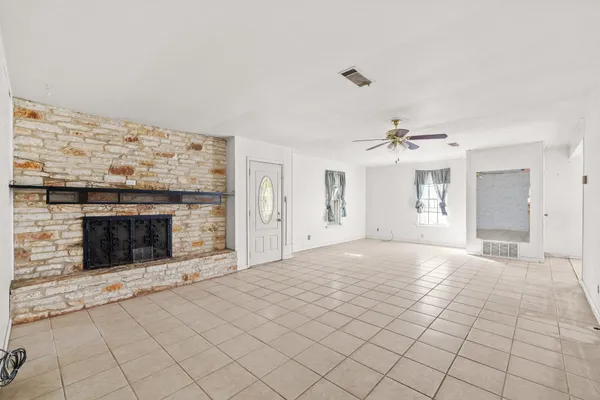 a view of a livingroom with an empty space and a fireplace