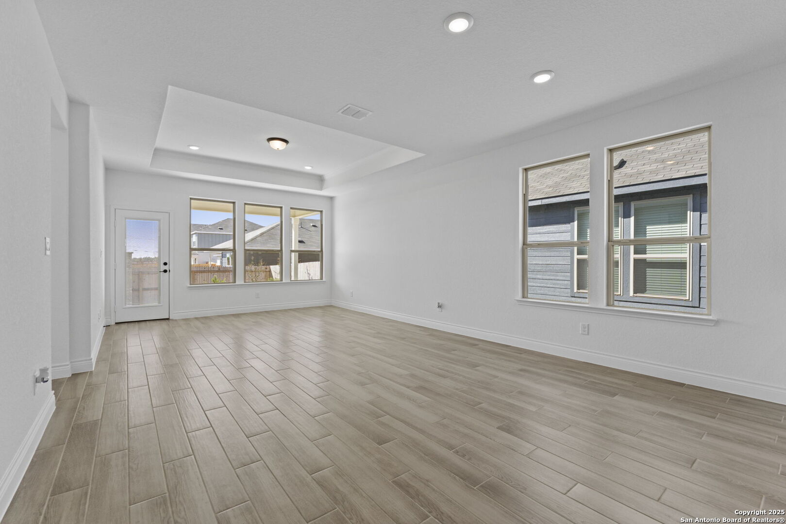 4014 Paddock Trail Seguin, TX 78155 - Photo 11 of 27 an empty room with wooden floor and windows
