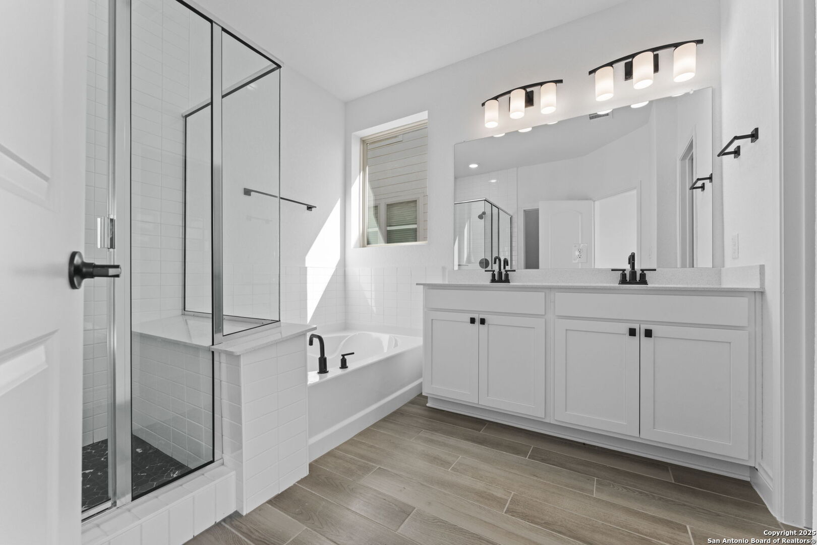 4014 Paddock Trail Seguin, TX 78155 - Photo 23 of 27 a bathroom with a double vanity sink mirror and shower