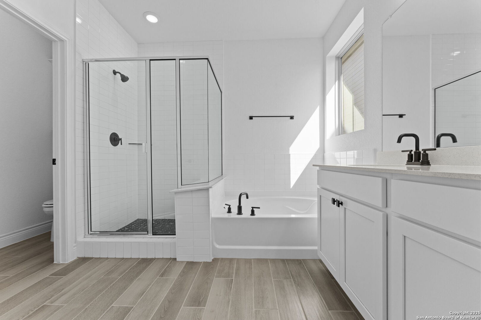 4014 Paddock Trail Seguin, TX 78155 - Photo 24 of 27 a bathroom with a sink a mirror and a bathtub