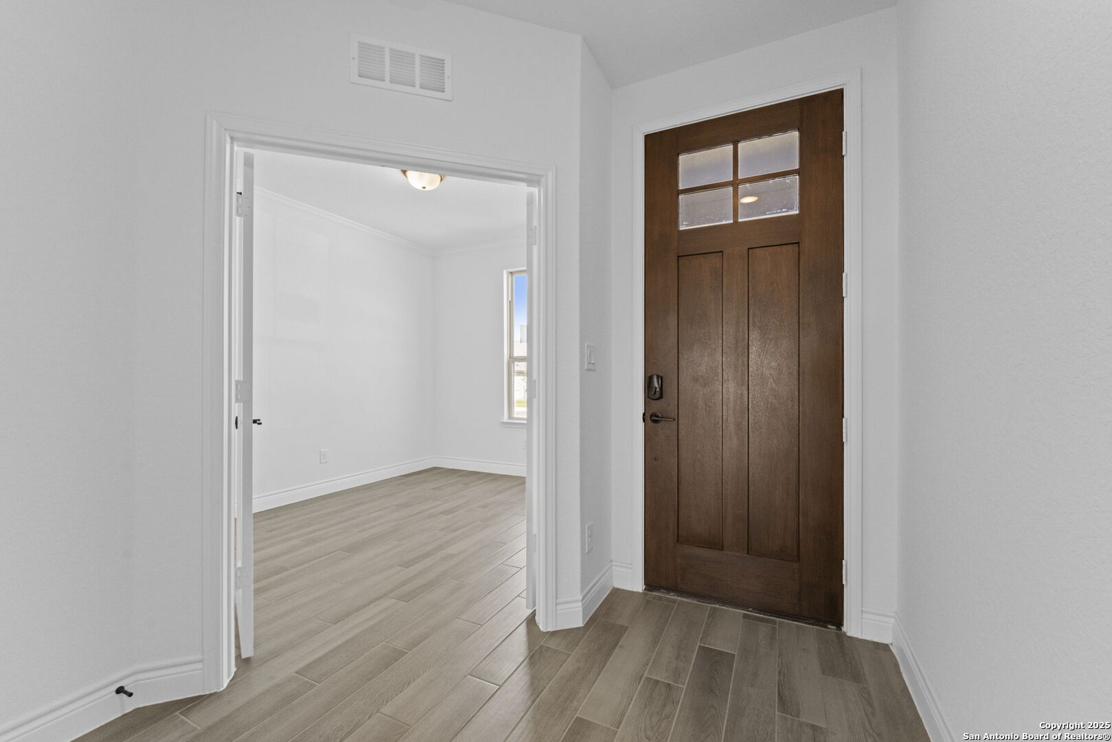 4014 Paddock Trail Seguin, TX 78155 - Photo 3 of 27 an empty room with wooden floor and closet