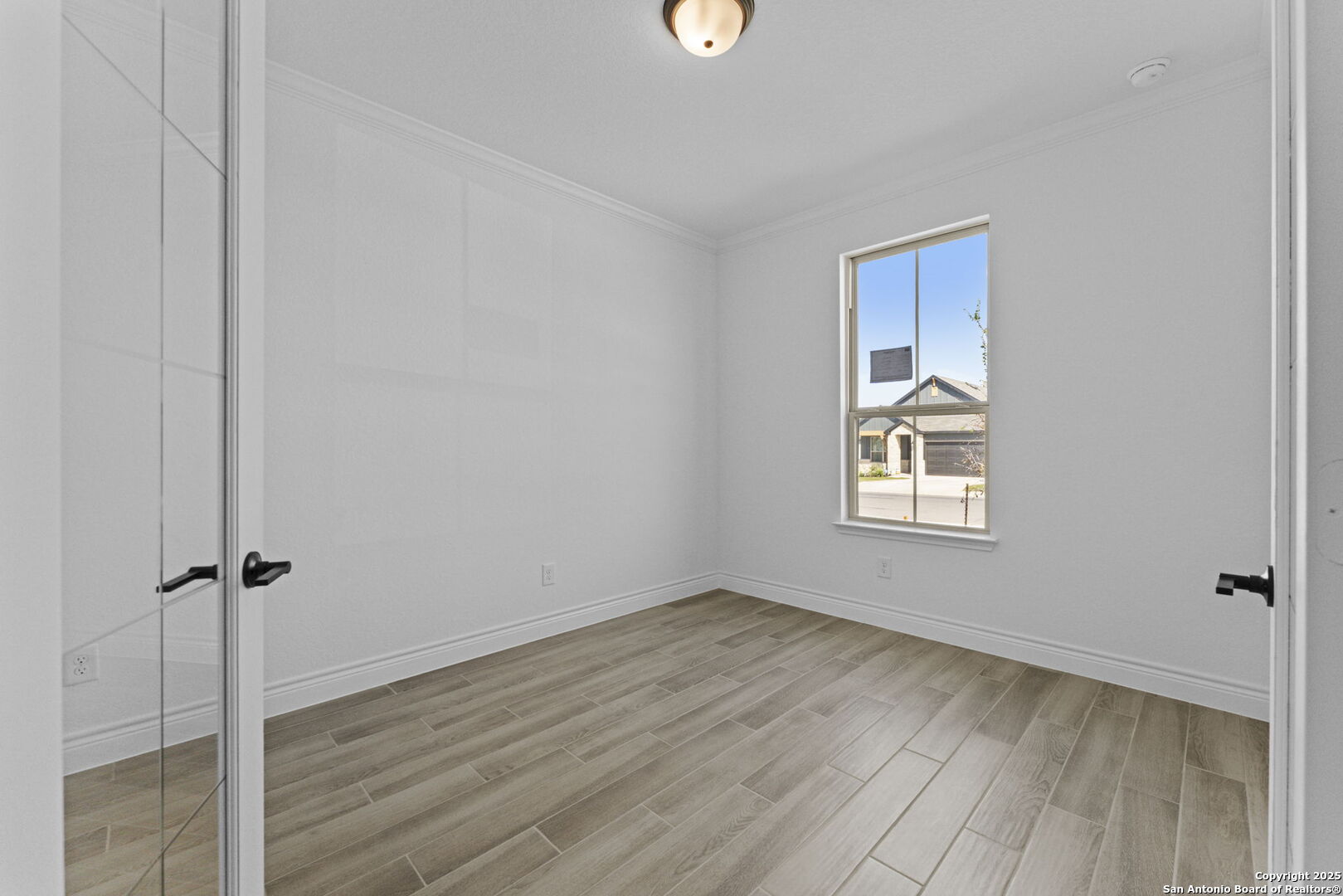 4014 Paddock Trail Seguin, TX 78155 - Photo 4 of 27 a view of a room with wooden floor and a window