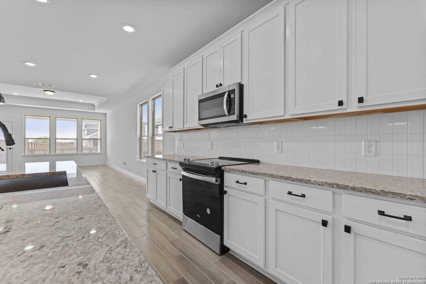 4014 Paddock Trail Seguin, TX 78155 - Photo 9 of 27 a kitchen with stainless steel appliances granite countertop white cabinets a sink and dishwasher