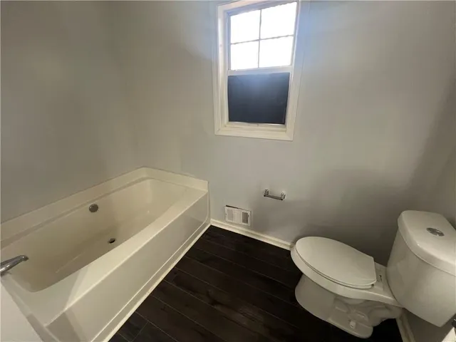 a bathroom with a toilet and a bathtub