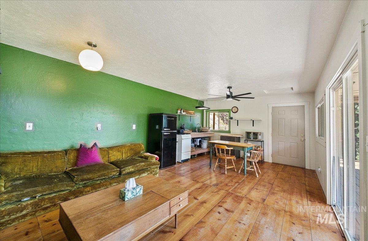 221 Tollgate Road Boise, ID 83716 - Photo 11 of 32 Living room featuring light wood-style floors, a ceiling fan, and a textured ceiling