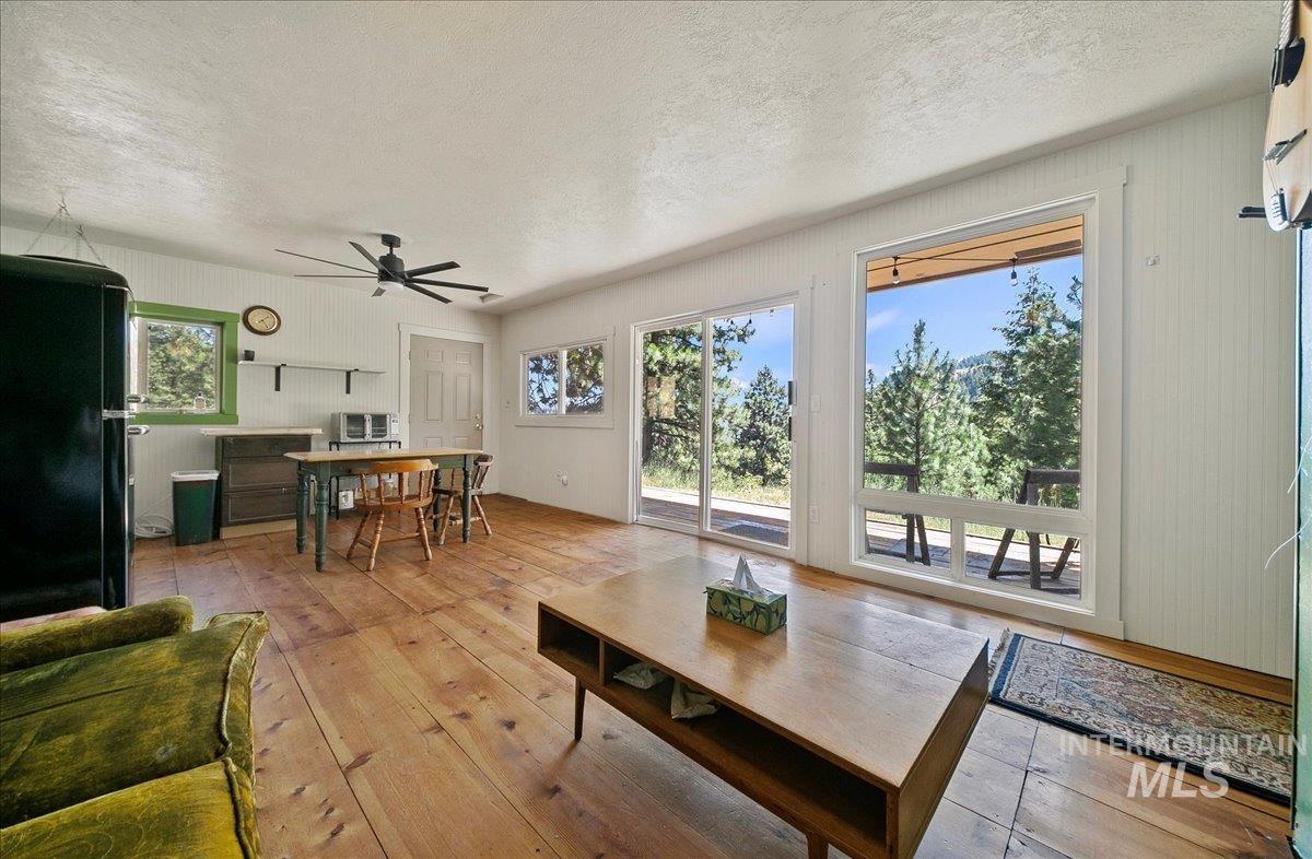 221 Tollgate Road Boise, ID 83716 - Photo 12 of 32 Living room featuring hardwood / wood-style floors, a textured ceiling, and ceiling fan