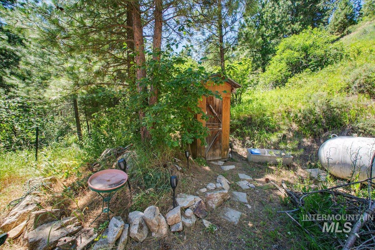 221 Tollgate Road Boise, ID 83716 - Photo 22 of 32 View of yard featuring a shed and a wooded view