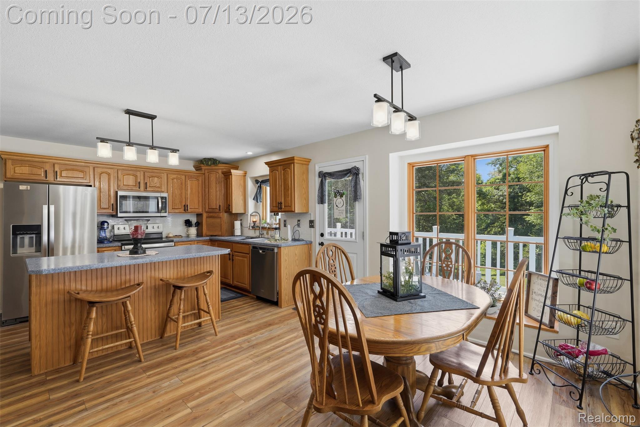 10525 Antcliff Road Brooklyn, MI 49230 - Photo 17 of 80 Kitchen featuring new laminate flooring and panoramic views from the wraparound porch