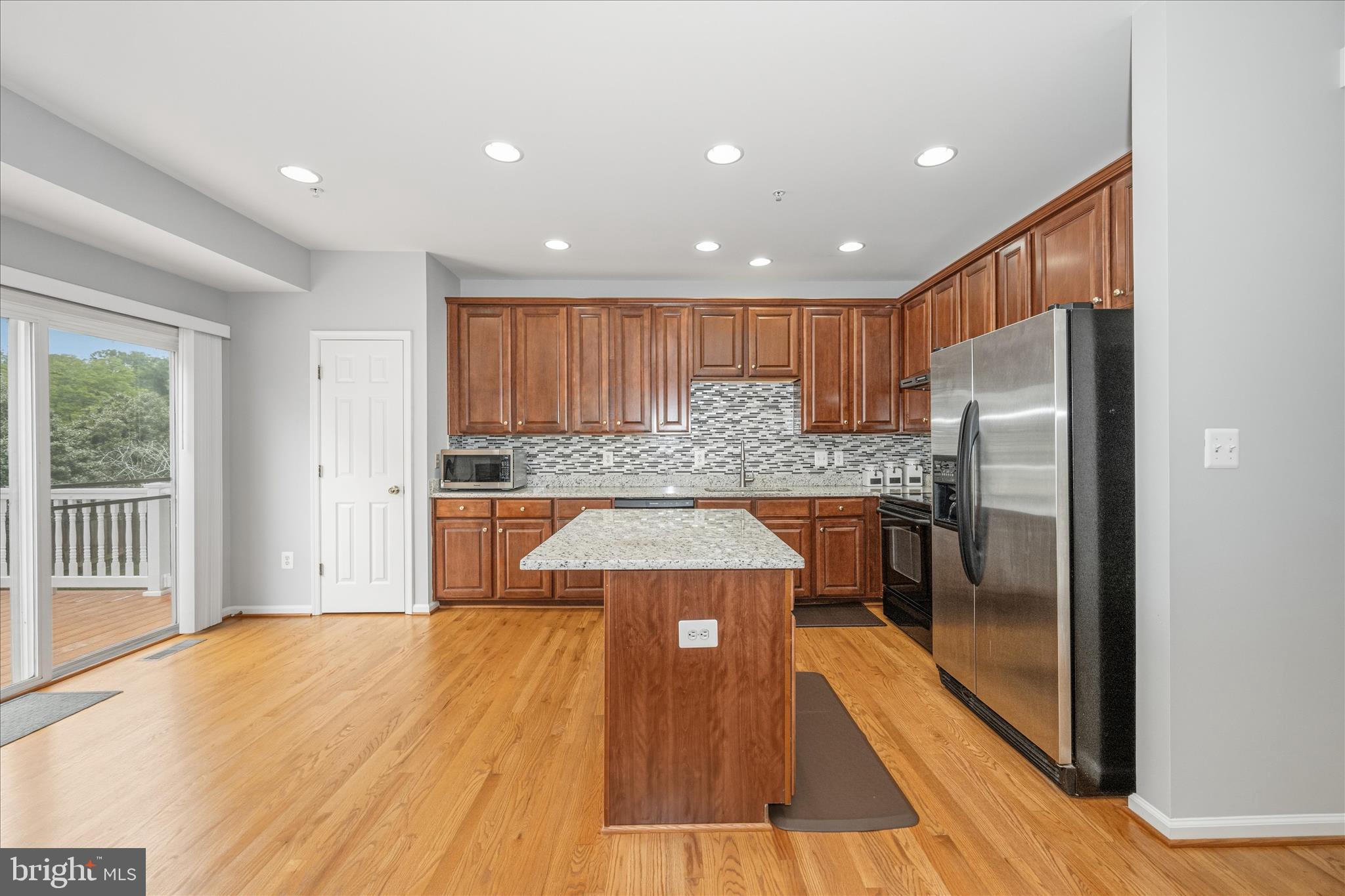 21 Inkberry Circle Gaithersburg, MD 20877 - Photo 14 of 51 a kitchen with kitchen island a counter top space a sink stainless steel appliances and cabinets