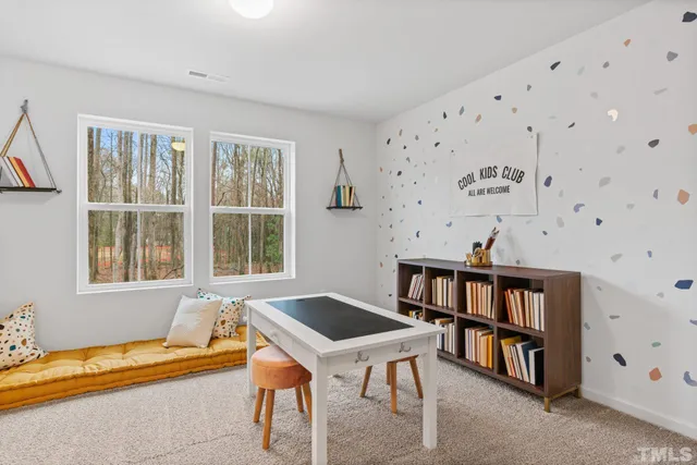 a bedroom with furniture and a large window