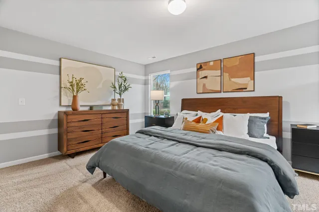 a bedroom with a bed and a dresser