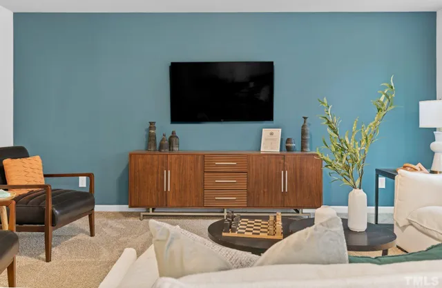 a view of a dining room with furniture and chandelier