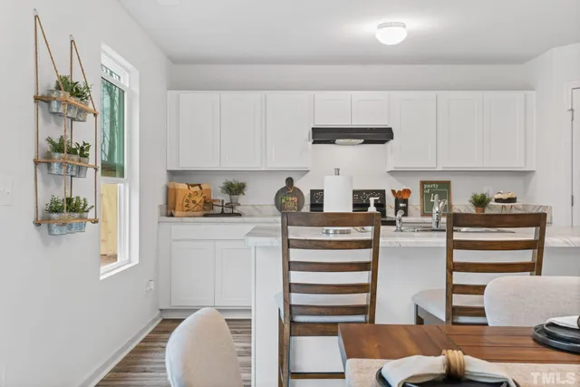 a view of a dining room with furniture wooden floor and a chandelier