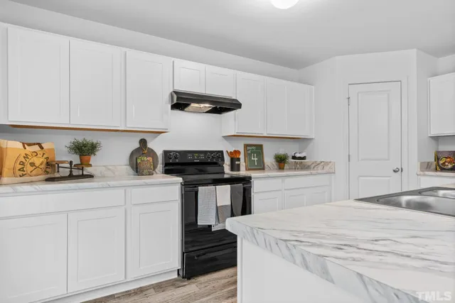 a kitchen with a sink and cabinets