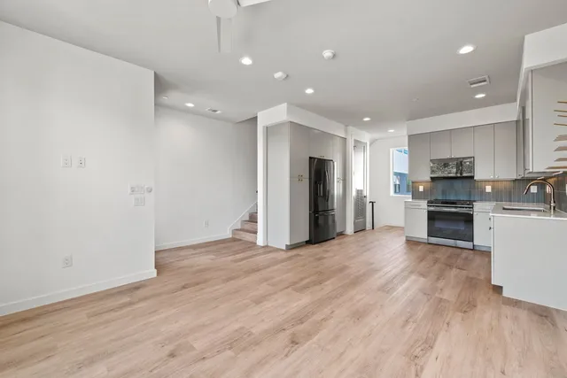 a view of kitchen with refrigerator stove microwave and cabinets