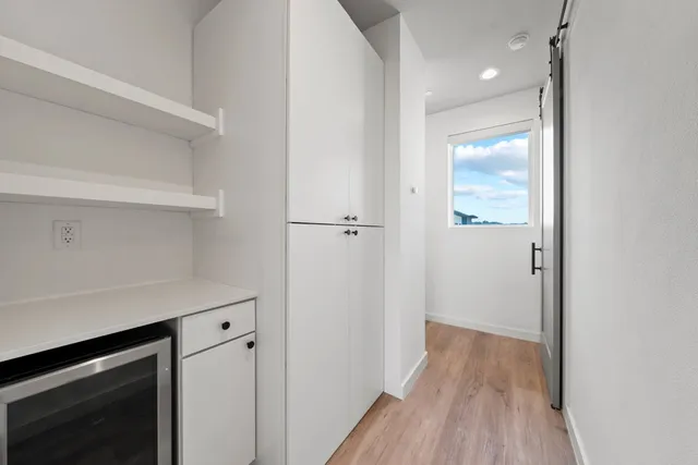 a view of hallway with wooden floor