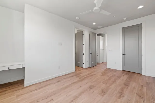 a bathroom with double vanity and a mirror