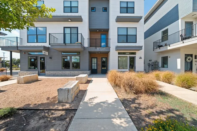 a front view of a building and car parked