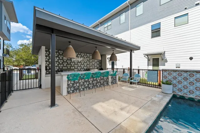 a view of a patio with table and chairs with wooden fence
