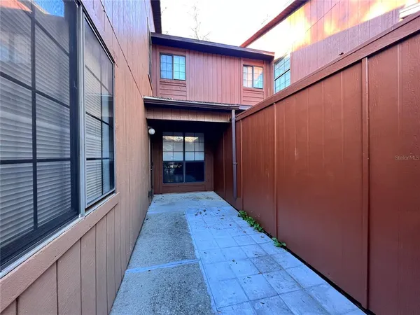 a view of a porch with wooden floor and stairs