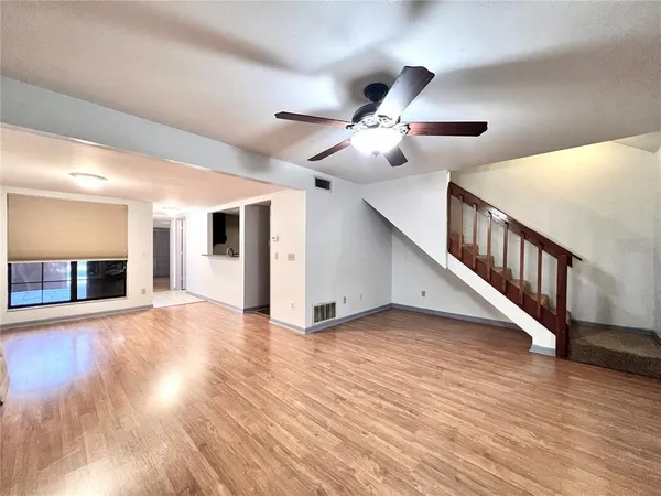 a view of an empty room with wooden floor